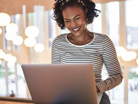 Woman on laptop smiling